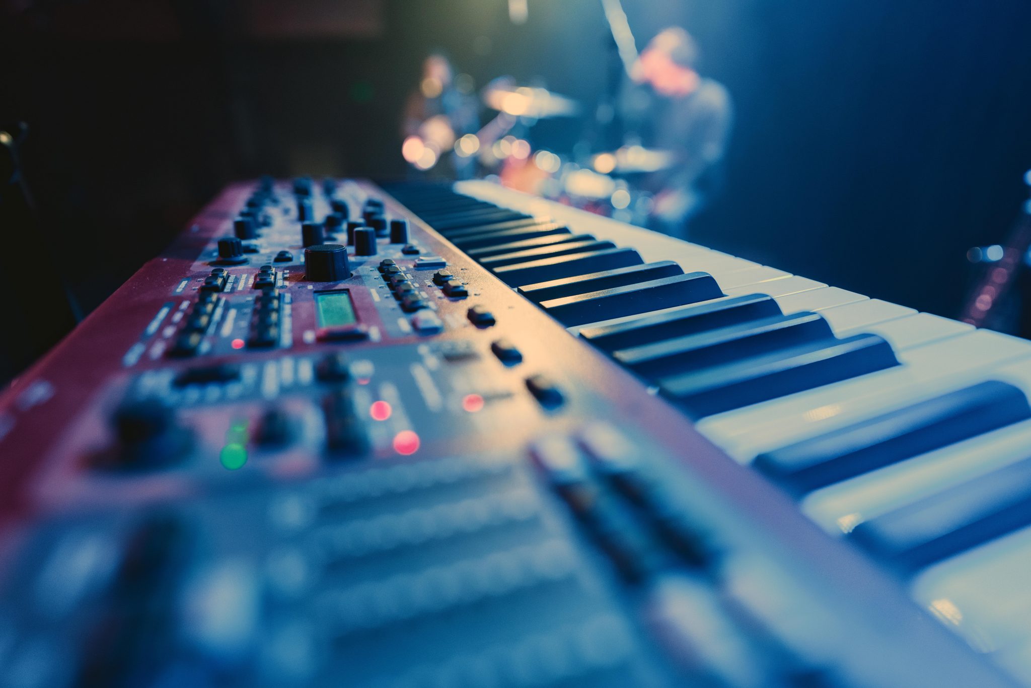 Film poster: a stage keyboard rig under blue light