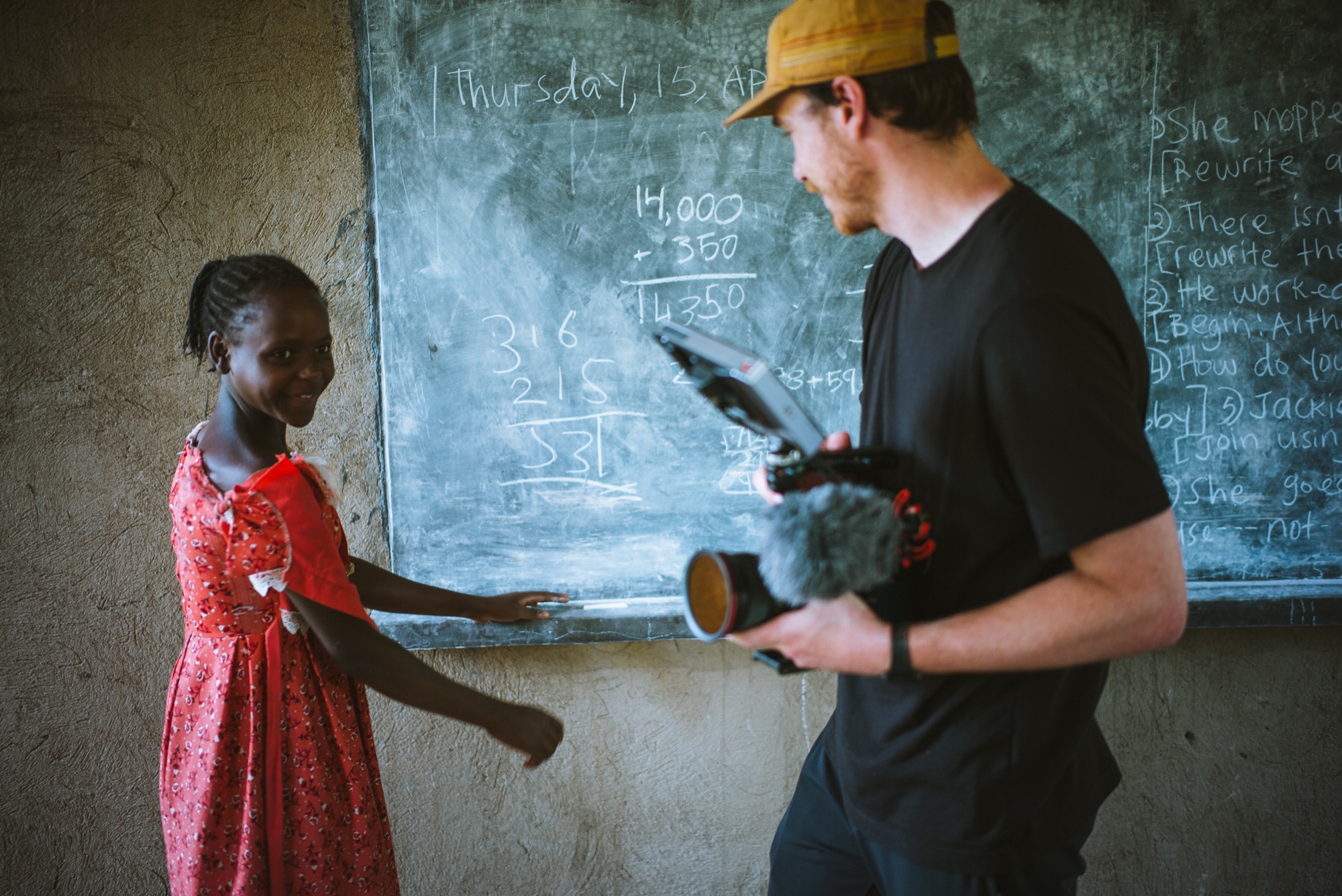 Handing the camera to a student at the chalkboard