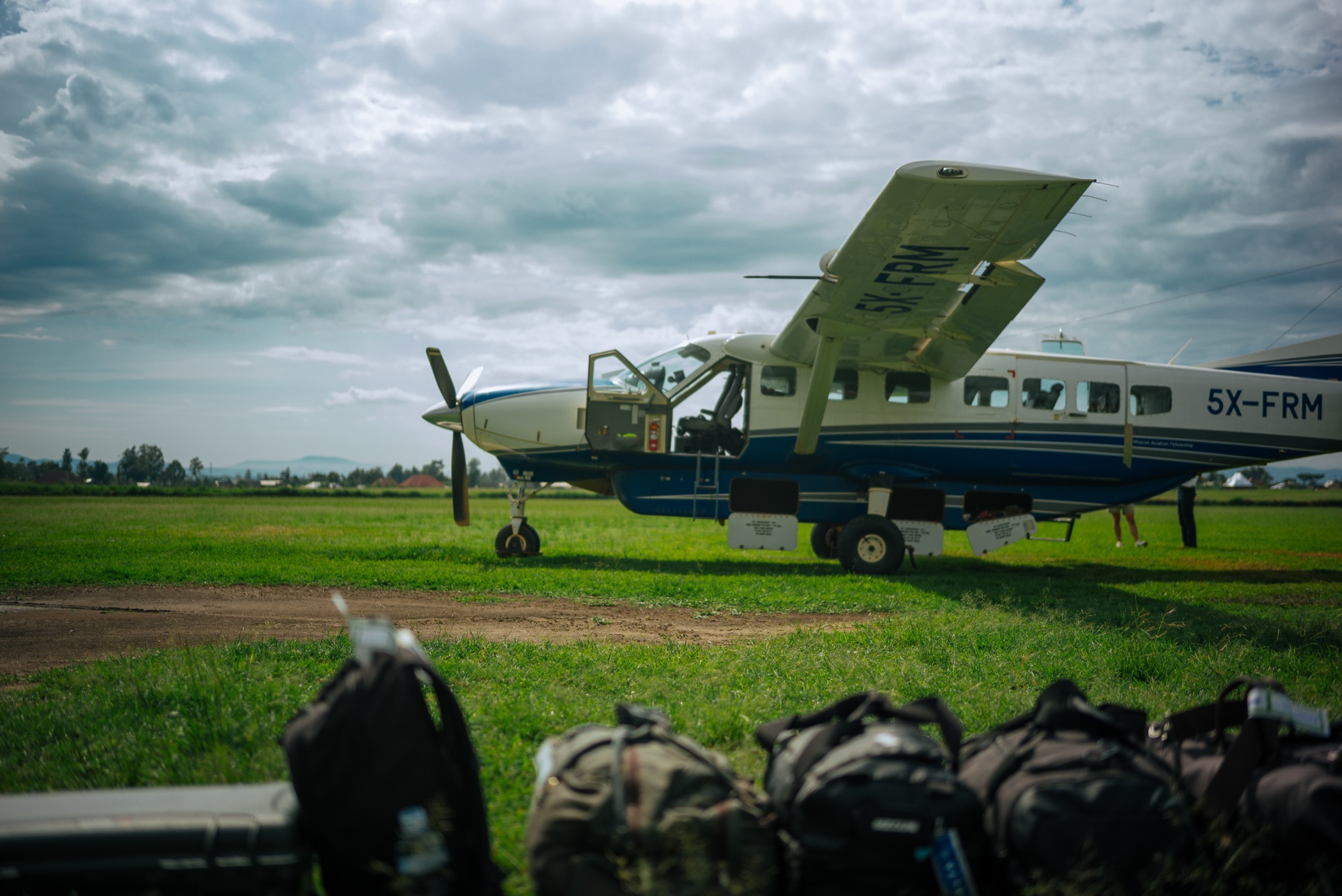 Loading the bush plane on a grass airstrip in Uganda