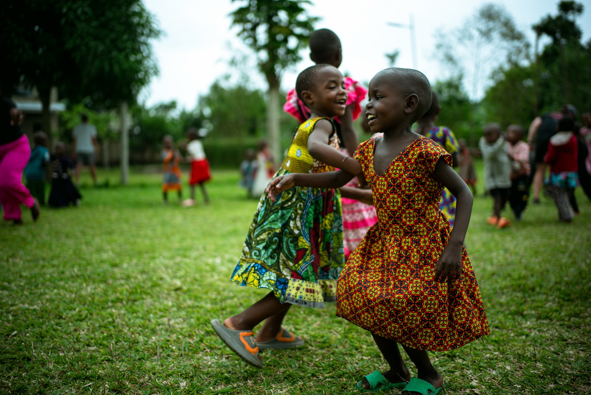 Kids dancing on the school lawn in Uganda