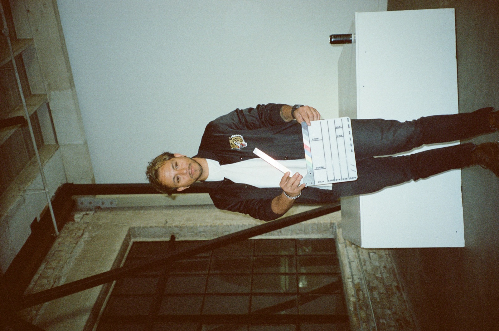 DJ on set holding the slate