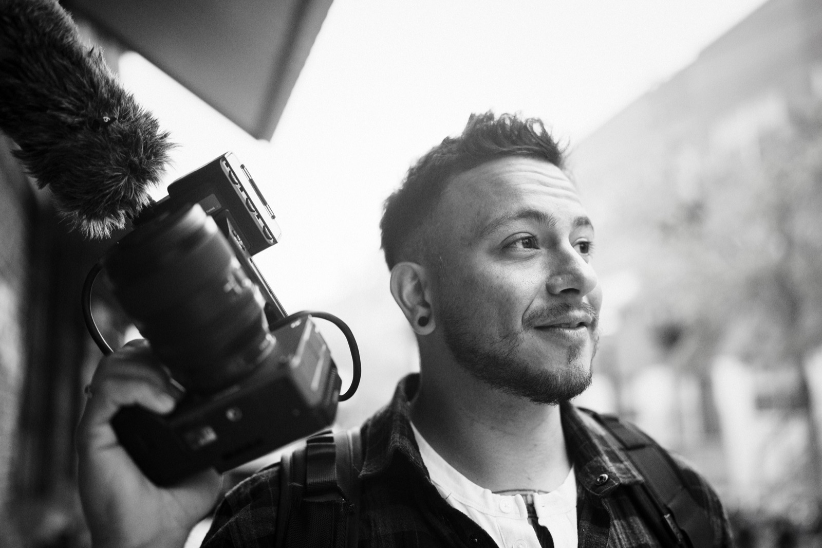 DJ with the camera and mic rig on his shoulder