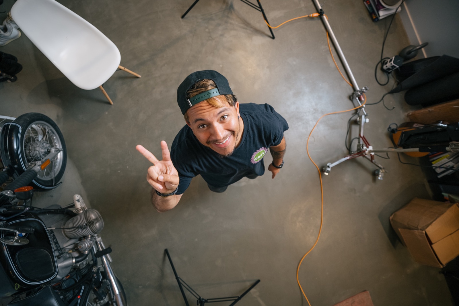 DJ looking up from the studio floor mid setup