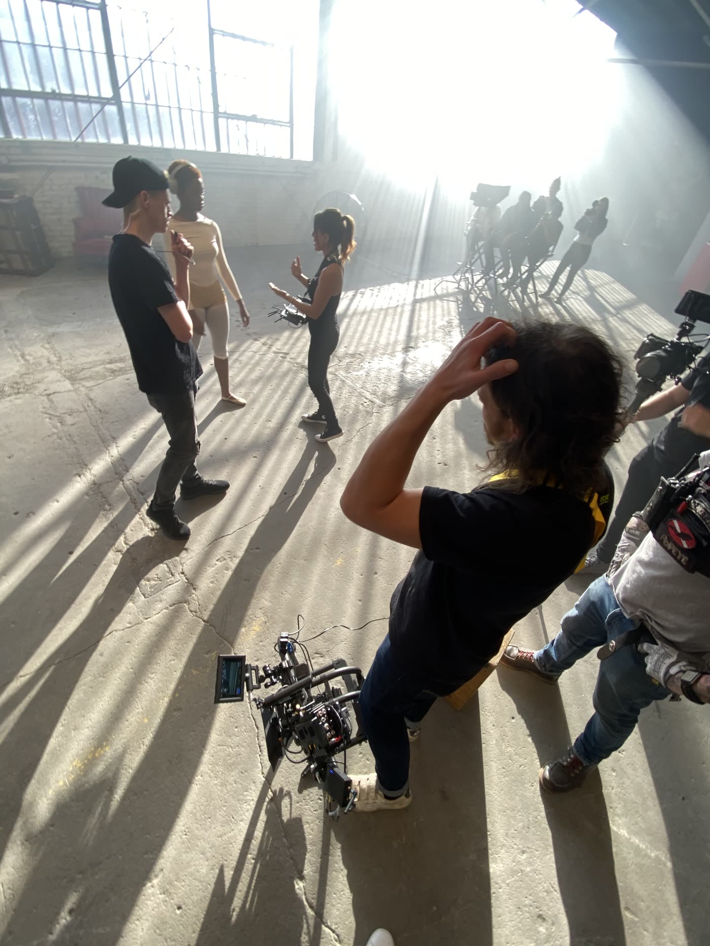 Dancers rehearsing in the warehouse light shafts