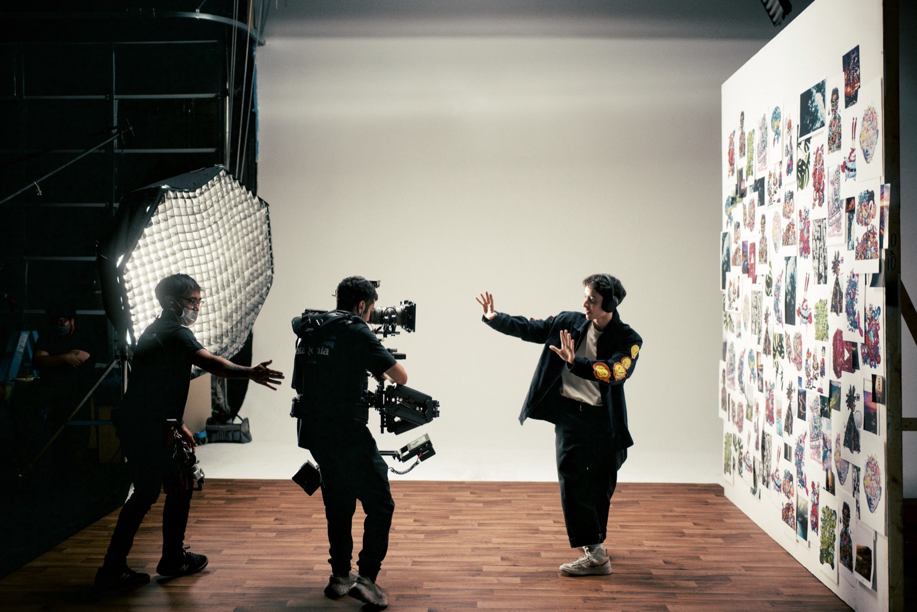 Crew filming Gawx against the art wall