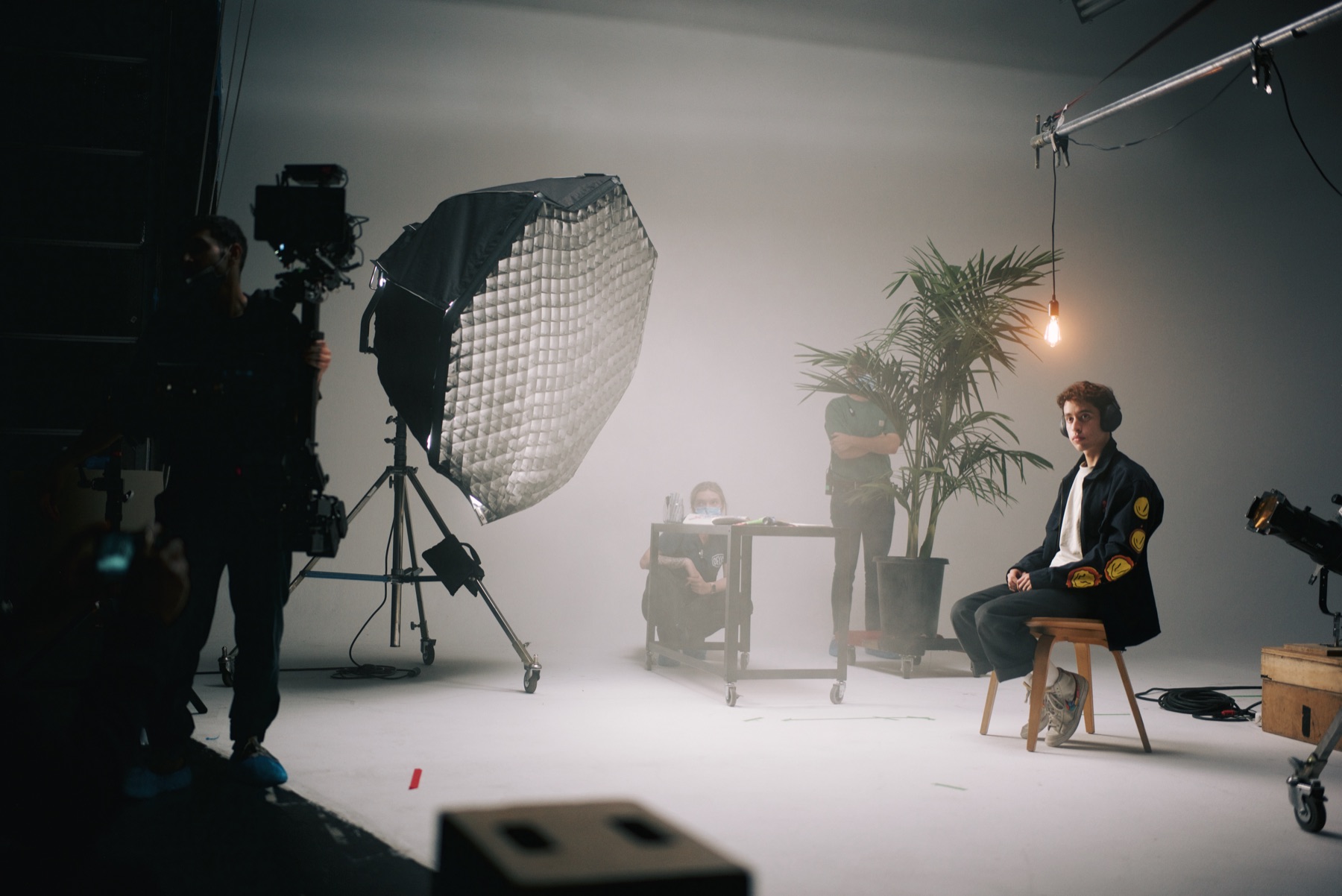 Wide studio setup with softbox and seated subject